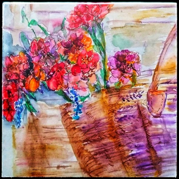 A watercolor painting featuring a bouquet of colorful flowers, including red, purple, and blue petals, arranged in a basket. The background showcases soft, blended colors that enhance the floral arrangement.